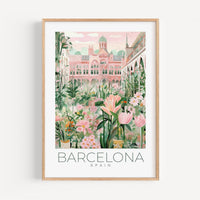 a framed print of barcelona with flowers and buildings in the background