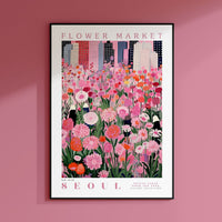 a pink flower market poster hangs on a pink wall