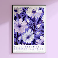 a purple and white poster hanging on a wall