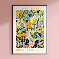 a flower market poster hangs on a pink wall
