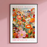 a flower market poster hangs on a pink wall