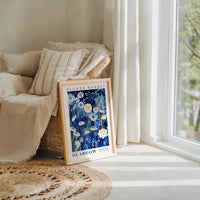 a picture frame sitting on a rug next to a window