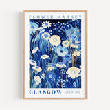 a blue and white flower market poster hanging on a wall