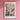 a pink wall with a picture of flowers on it