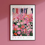 a pink flower market poster hangs on a pink wall