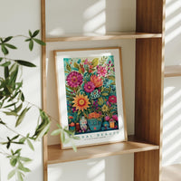 a picture of a vase of flowers on a shelf