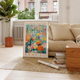 a living room with a couch and a poster on the floor