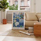 a living room with a couch and a poster on the floor