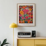 a picture of a vase of flowers on a wall above a radio