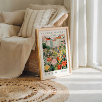 a picture of a flower market on display in front of a window