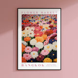 a flower market poster hanging on a pink wall