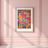 a pink wall with a picture of a vase of flowers