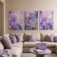 a living room filled with furniture and paintings on the wall