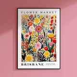 a flower market poster hanging on a pink wall
