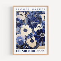 a blue and white flower market poster hanging on a wall