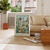 a living room with a couch and a poster on the floor