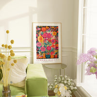 a living room with a green couch and a vase of flowers