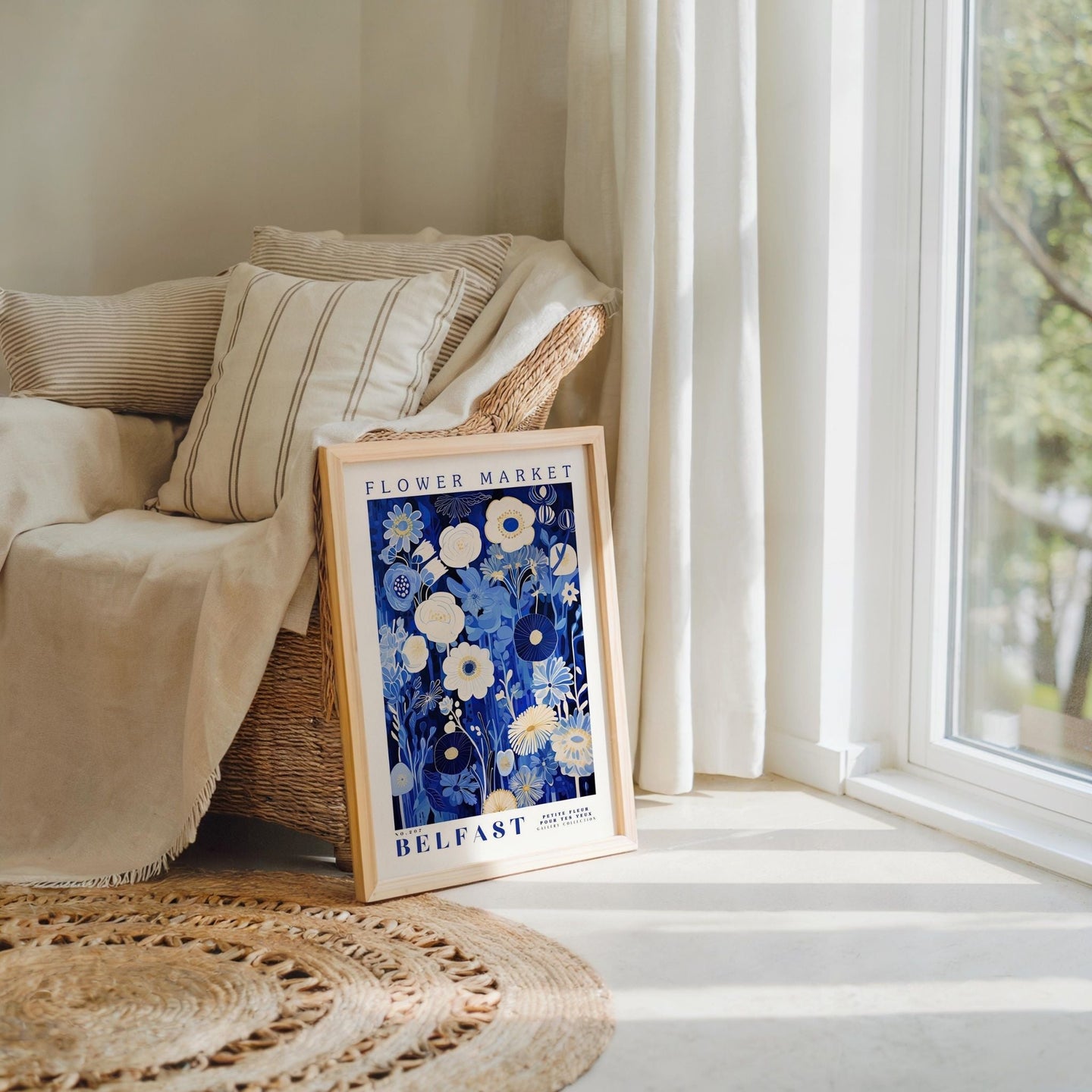 a picture frame sitting on a rug next to a window