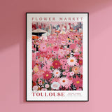 a pink flower market poster hangs on a pink wall