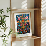 a picture of a painting on a shelf next to a potted plant