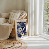 a picture frame sitting on a rug next to a window