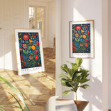 two paintings of flowers are hanging on the wall