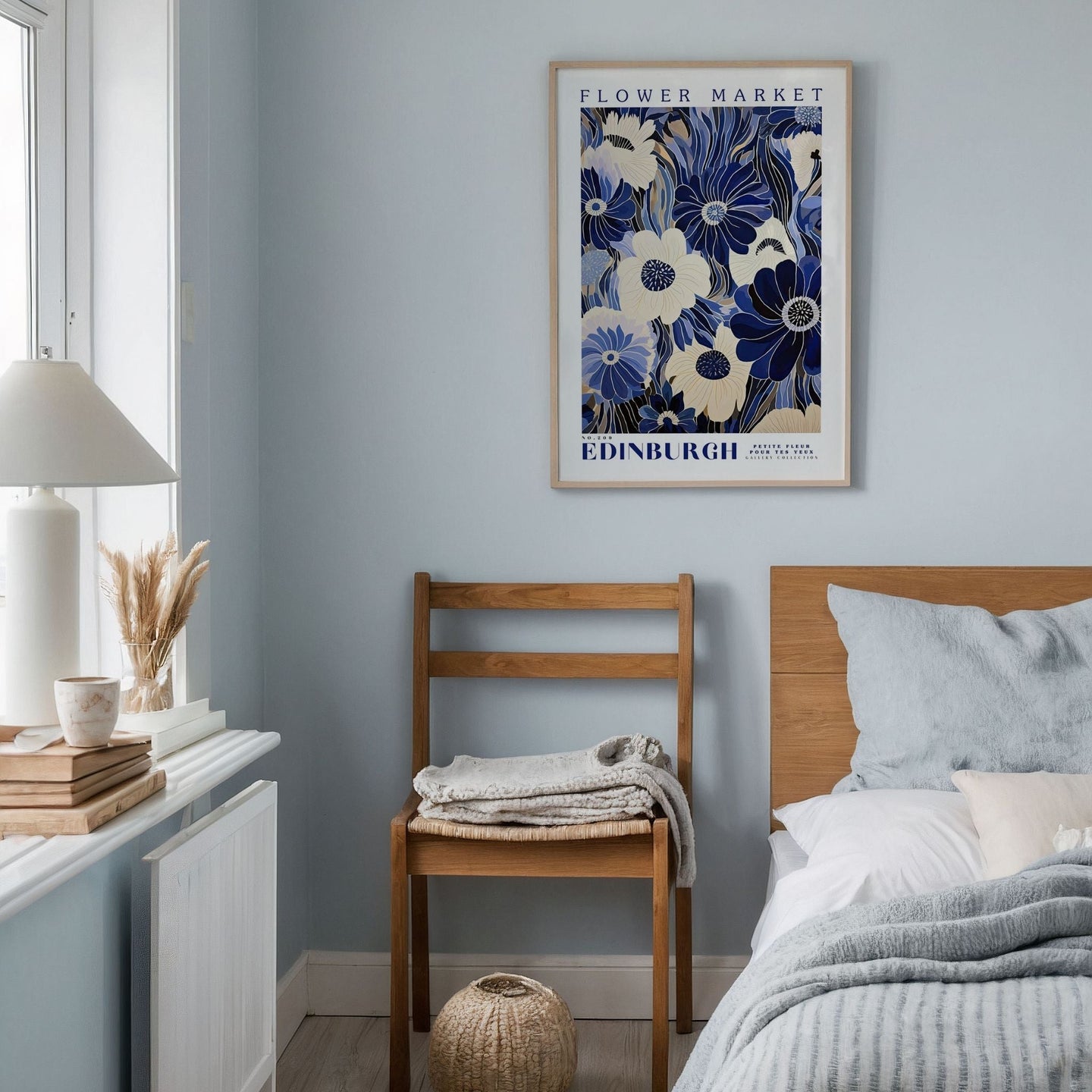 a bedroom with a bed, a chair and a picture on the wall