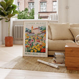 a living room with a couch and a poster on the floor