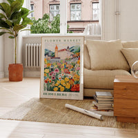 a living room with a couch and a poster on the floor