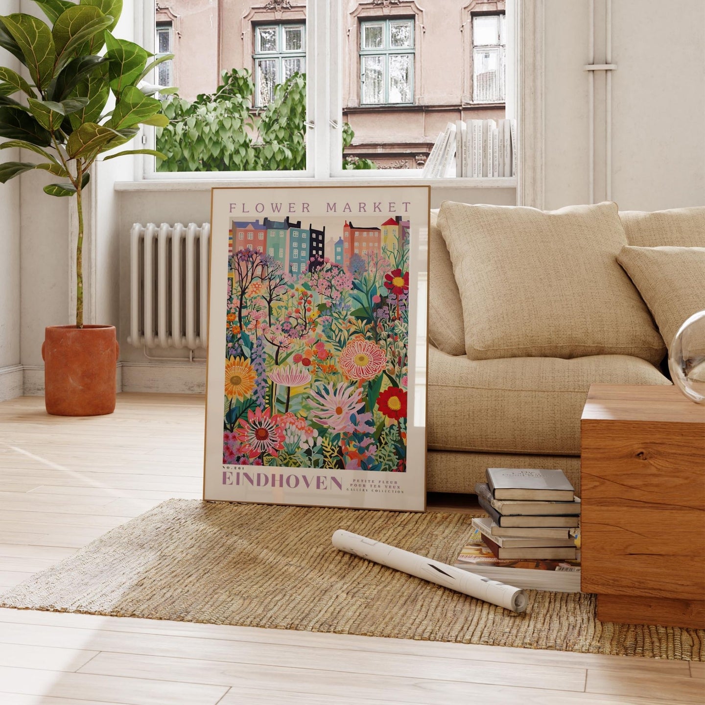a living room with a couch and a painting on the floor