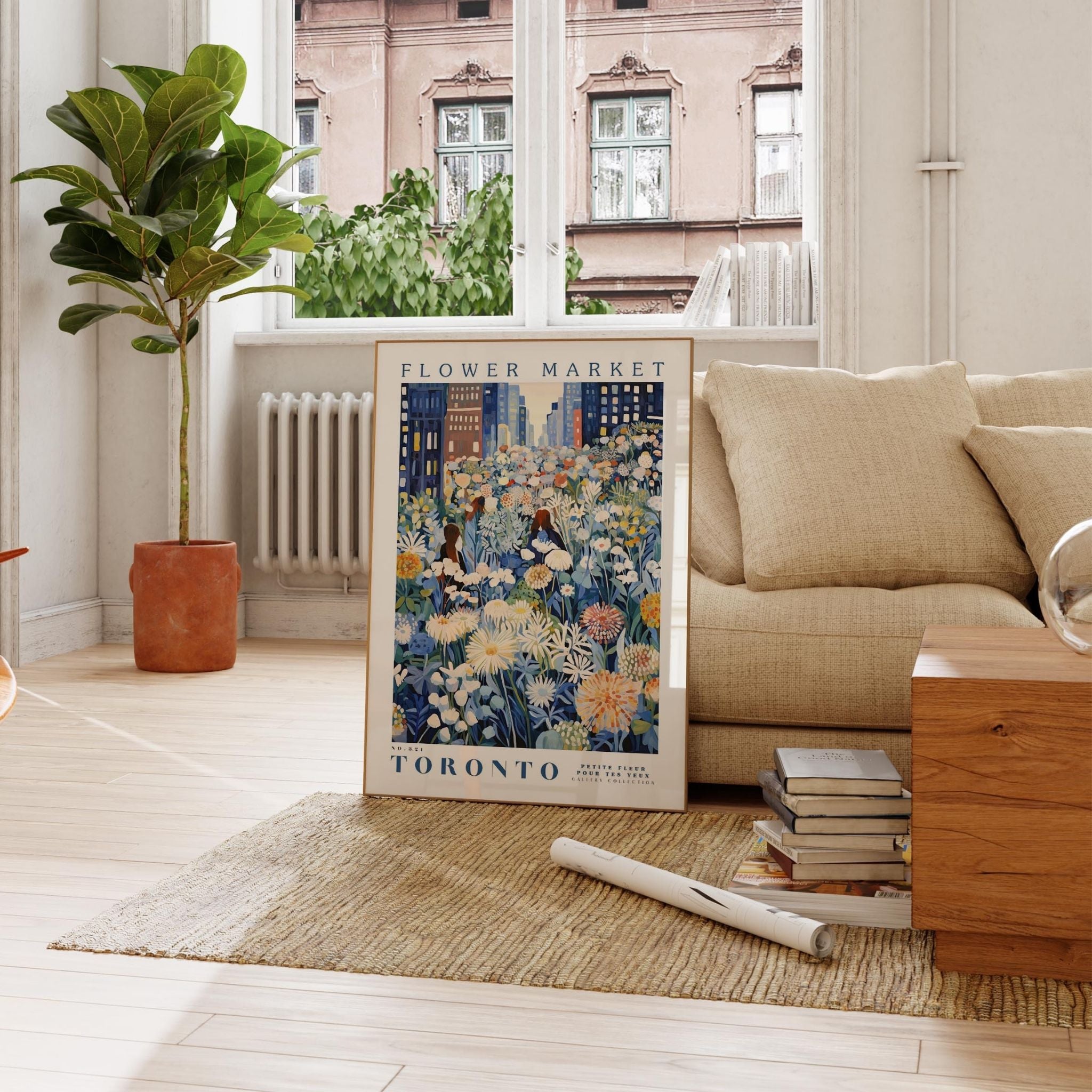 a living room with a couch and a painting on the floor