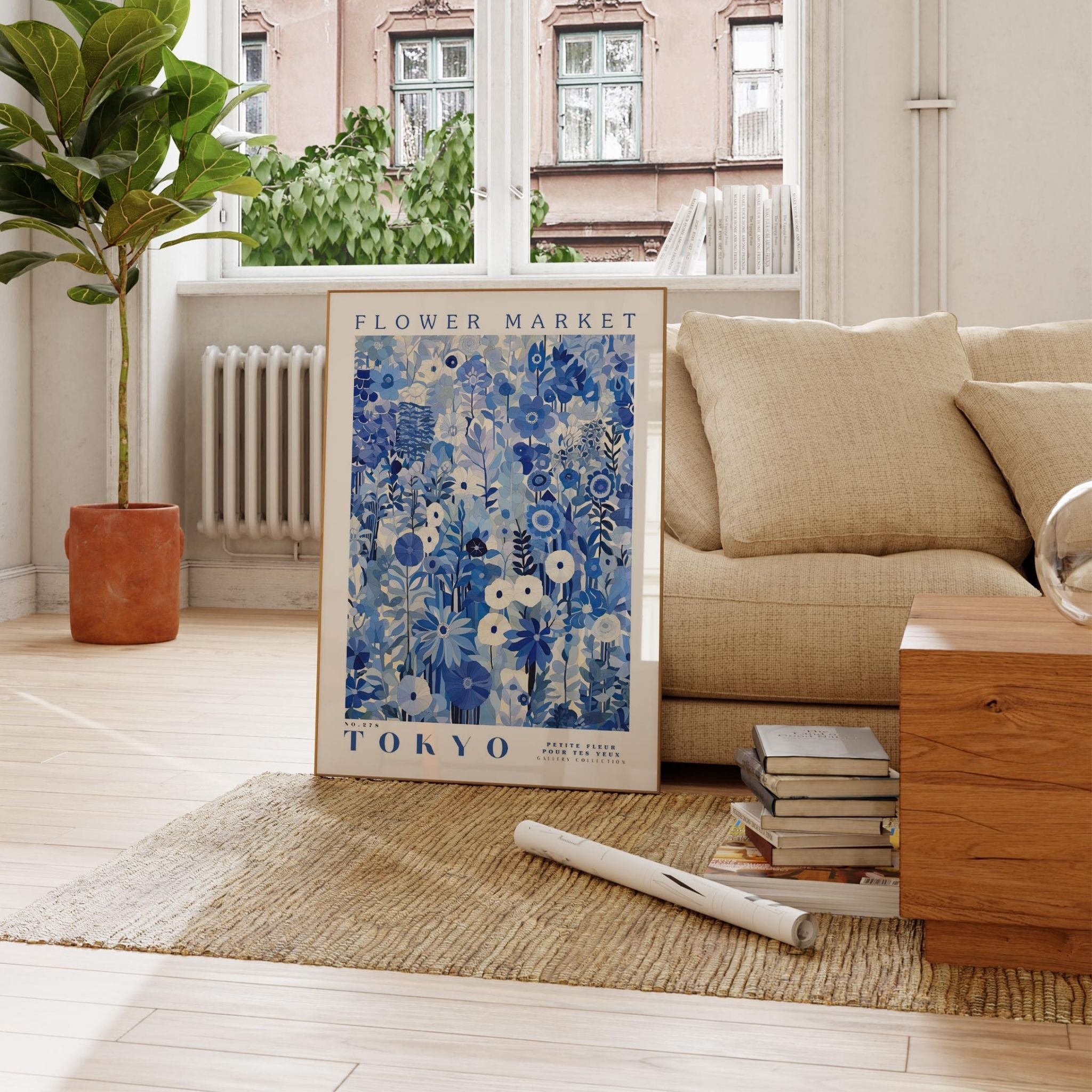 a living room with a couch and a poster on the floor